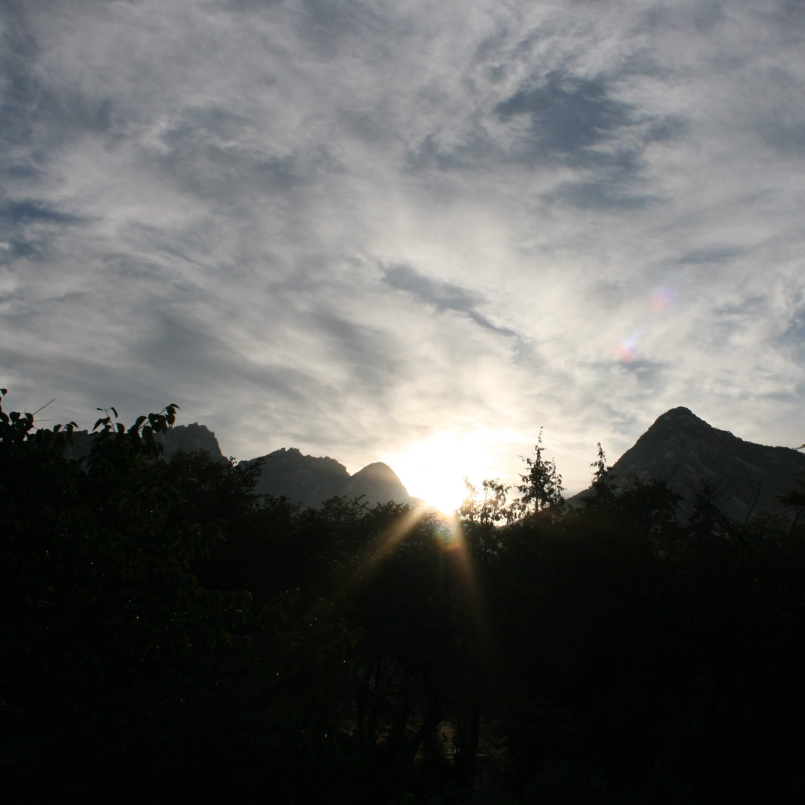 mountains with sun setting behind