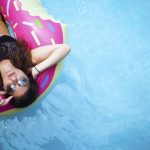 woman floating in a pool looking up