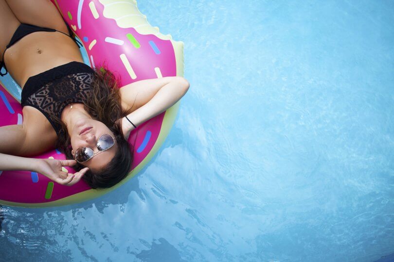 woman floating in a pool looking up