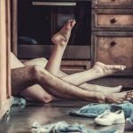 intertwined legs of a man and woman laying on the ground